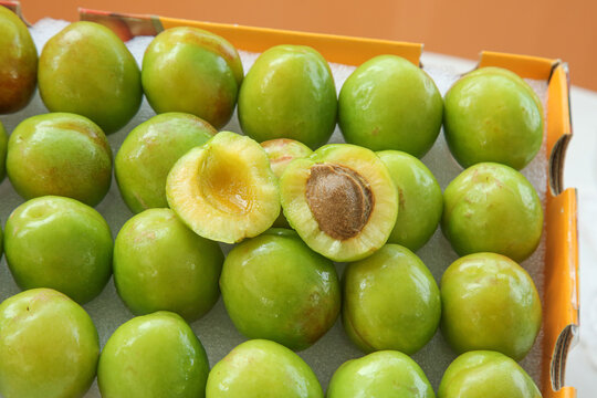 Fresh Green-Skinned Plums from Aksu Xinjiang China in Market Crate Display
