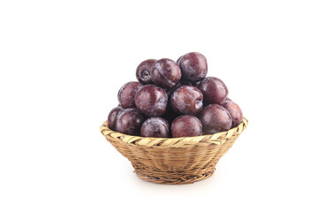 Fresh Red Purple Plums in Wicker Basket on White Background - Organic Stone Fruit