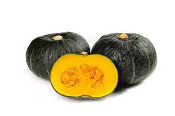 Fresh Kabocha Pumpkin Squash Cut in Half Showing Orange Flesh on White Background