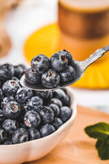 Fresh Blueberries in Bowl with Spoon for Casual Afternoon Tea and Healthy Snacking
