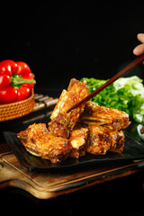 Grilled Lamb Chops with Golden Shine on Wooden Board with Fresh Vegetables
