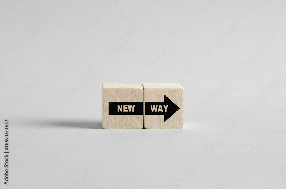 Poster two wooden cubes showing new way forward with arrow