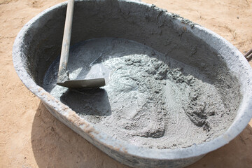 Cement mixer with shovel and cement