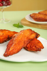 Crispy Fried Chicken Wings with Fresh Herbs on White Plate - Gourmet Food Photography