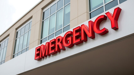 Red Emergency Sign on Modern Hospital Building for Urgent Medical Care