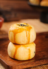 Handmade Golden Pastries with Black Sesame Seeds on Wooden Board - Traditional Asian Bakery Dessert