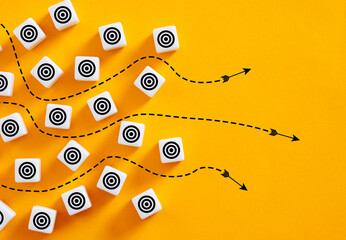 Arrows pointing different targets on yellow background representing alternative strategies