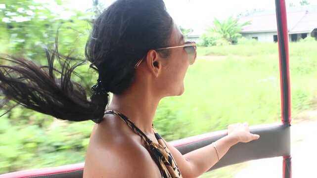 Young woman sitting in the sidecar of a moving motorbike