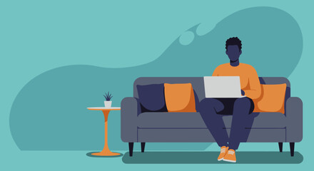 African American man comfortably working from home on a laptop. Ideal for themes of remote work, online education, and digital lifestyle.