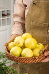 Fresh Golden Passion Fruit in Wicker Basket Held by Woman in Kitchen - Organic Harvest and Healthy...