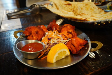 Indian Chicken Tikka Served with Lemon and Salad