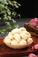 Fresh Peeled Garlic Cloves in Wooden Bowl - Farmhouse Kitchen Ingredients Closeup
