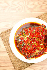 Spicy Steamed Fish Head with Chopped Chili Peppers and Red Sauce on White Plate
