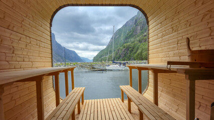 Relaxing inside a charming wooden sauna cabin with expansive views of Lysefjord Norway