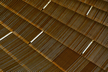 Close-up of modern building material with repeating wooden slats creating rhythm, texture, and...