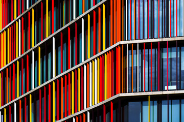 Vibrant office building façade with colorful vertical panels creating rhythm, contrast, and...