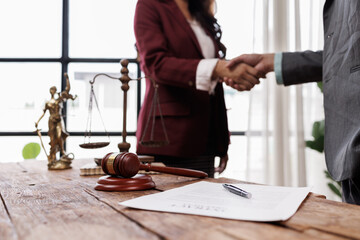 Professional Lawyer Handshake in Business Meeting with Scales of Justice and Gavel on Desk,...