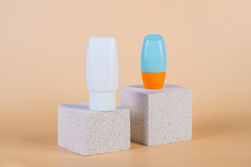 Cosmetic product in tube, bottle, lotion or serum with stylish props on cream background. 