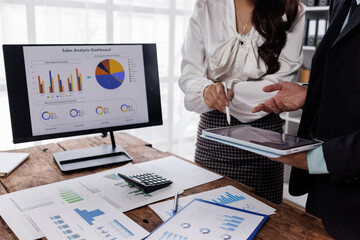 financial Business team analyzing advisory services. Team of advisor showing plan of investment to clients in the consultancy office.
