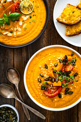 Pumpkin cream soup on wooden table