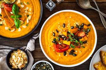 Pumpkin cream soup on wooden table