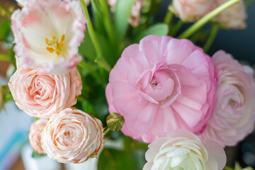Elegant and gentle floral arrangement of pink ranunculus and roses