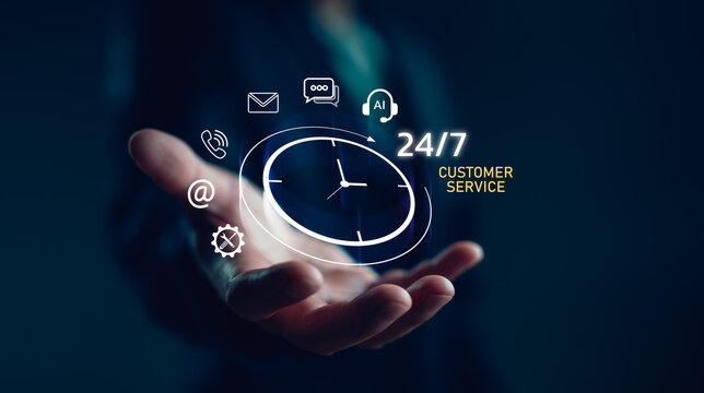 Businessman hand holding a virtual interface showing 24/7 AI customer service icons, representing around-the-clock support, artificial intelligence and digital communication technology.