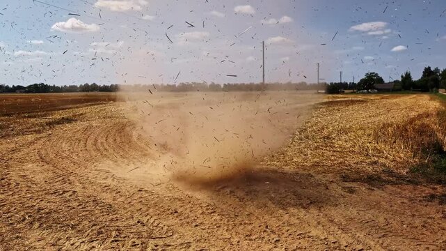 Dry land from drought results in sandy soil that the wind whips into a small tornado or dust devil