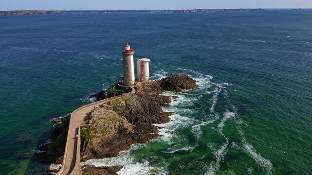 Aerial of Petit Minou lighthouse centered on rocky coast near Plouzane, Brittany, France, establishing pullback