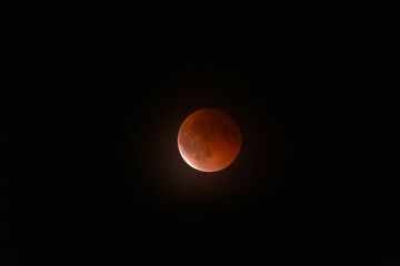 observe the blood moon with shadow of the earth over Austria in a dark night