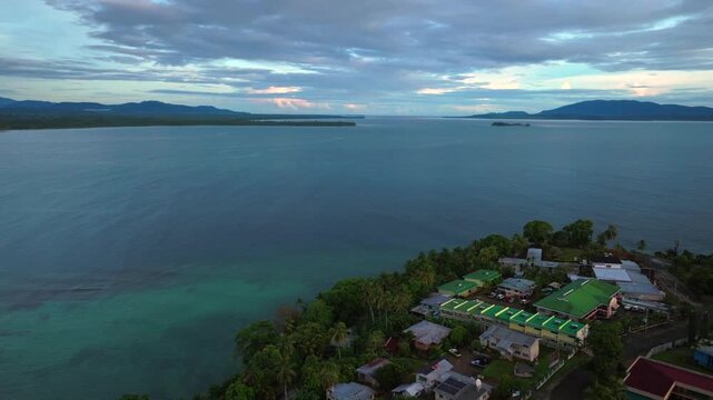 Early morning Yuo Mushu Island Wewak Hill Cape Wom peninsula morning summer dry season Wewak costal town aerial drone Papua New Guinea PNG Dogreto Bay panoramic ocean view Boram Road backwards motion