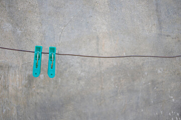 Laundry background. Clothespins on a clothesline. Drying clothes outdoors with clothespins. How to...
