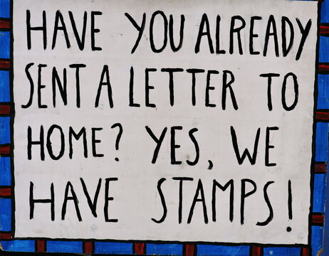 Have you already sent a letter to home? Yes we have stamps!  (Etes vous pr&ecirc;ts &agrave; envoyer une lettre &agrave; la maison? Oui nous avons des timbres). Inscription en anglais, caract&egrave;res noirs sur fond blanc.