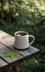 Steaming Mug of Tea on Rustic Wooden Table with Autumn Leaf hot drink beverage