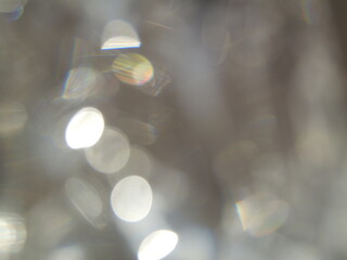 White bokeh FX background. Soft abstract bokeh with rainbow highlights, creating an atmosphere of...