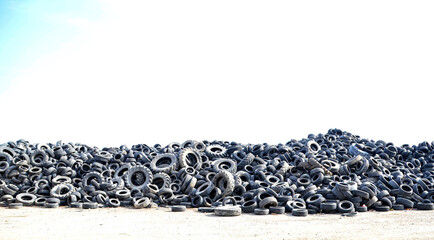 A huge pile of discarded and used waste tires collected for recycling and reuse, highlighting the issue of environmental waste and the recycling process. © IbrahimAlkan
