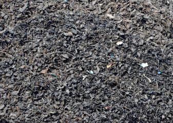 Shredded waste tires collected in a pile, ready to be recycled into new products. This process is vital for sustainable waste management.