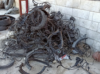 A chaotic pile of steel wires and rubber pieces, once part of vehicle tires, now separated for...