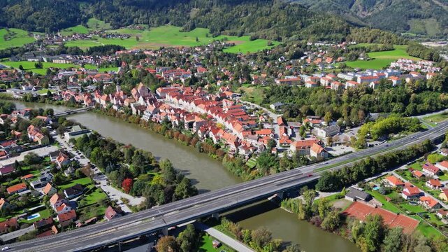 Aerial view of the town of Frohnleiten, showcasing terracotta rooftops and the Mur River cutting through a valley, Frohnleiten, Styria, Austria.