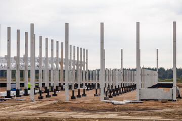 Construction of industrial buildings made of reinforced concrete structures. General view of the construction site.