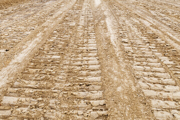 Traces of heavy tracked vehicles on a sandy area. The background image.