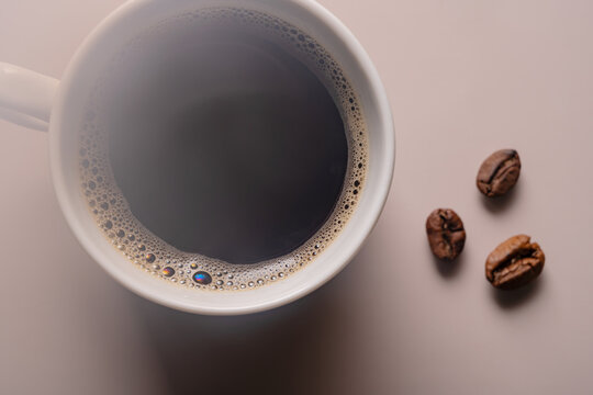 Coffee cup with roasted beans on a light background - Powered by Adobe