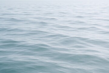 Fototapeta premium Calm ocean surface reflecting soft light during early morning hours