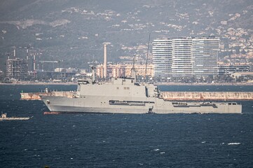 Spanish Navy amphibious ship Galicia anchored in Málaga, Spain. Coastal buildings and port visible in the background during naval operations
