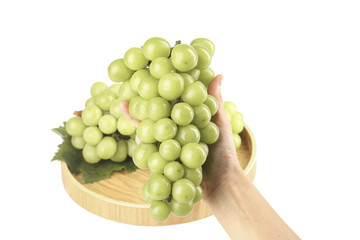 Fresh Green Grapes Bunch in Hand on Wooden Plate White Background