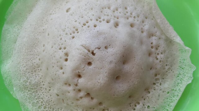 Appam, kalappam, vellayappam or palappam popular traditional rice flour vegetarian dish for breakfast and dinner in south Indian states Karnataka, Tamil Nadu and Kerala. Closeup macro top view.