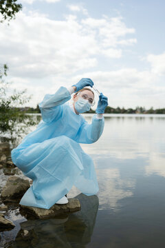 Young biologist conducting fieldwork by the water
