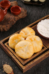 Traditional Chinese Moon Cakes with Baking Ingredients on Rustic Wooden Tray for Mid-Autumn Festival
