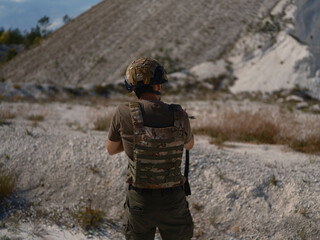 Ukrainian Soldier Standing and Aiming in a Chalk Quarry
