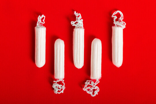 Tampons arranged on a vibrant red surface